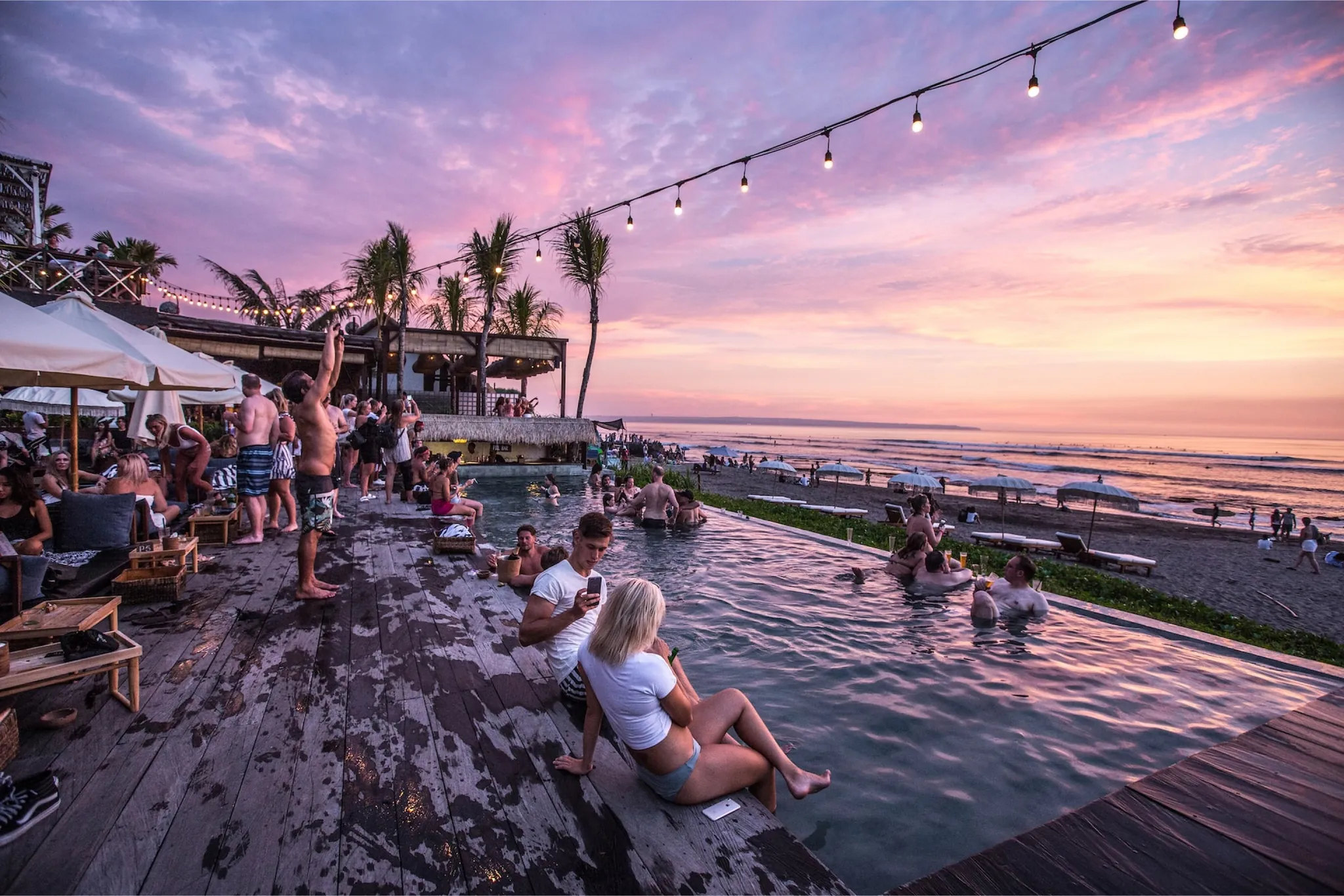 A beach club pool at sunset on the Canggu coast